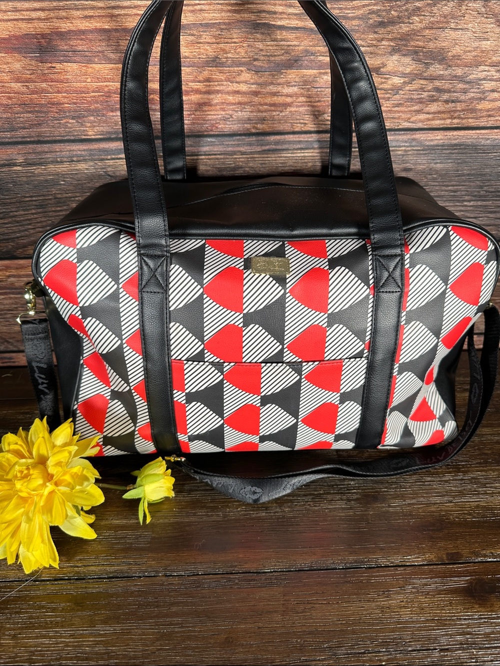 Luv Betsey by Betsey Johnson weekender bag features a vibrant geometric design